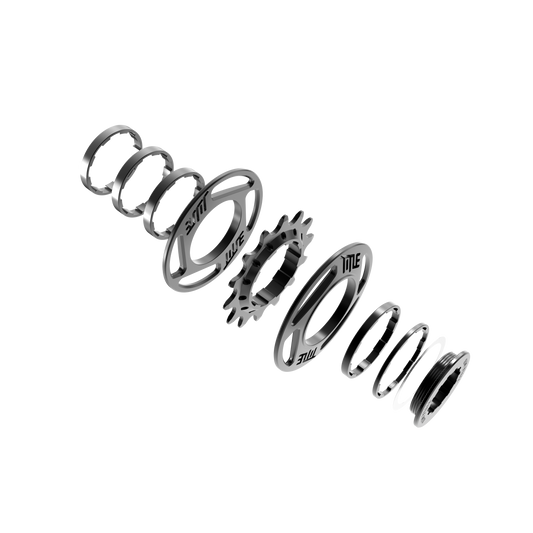 Exploded view of Title MTB Single Speed Kit, showing gears and spacers arranged on a white background.